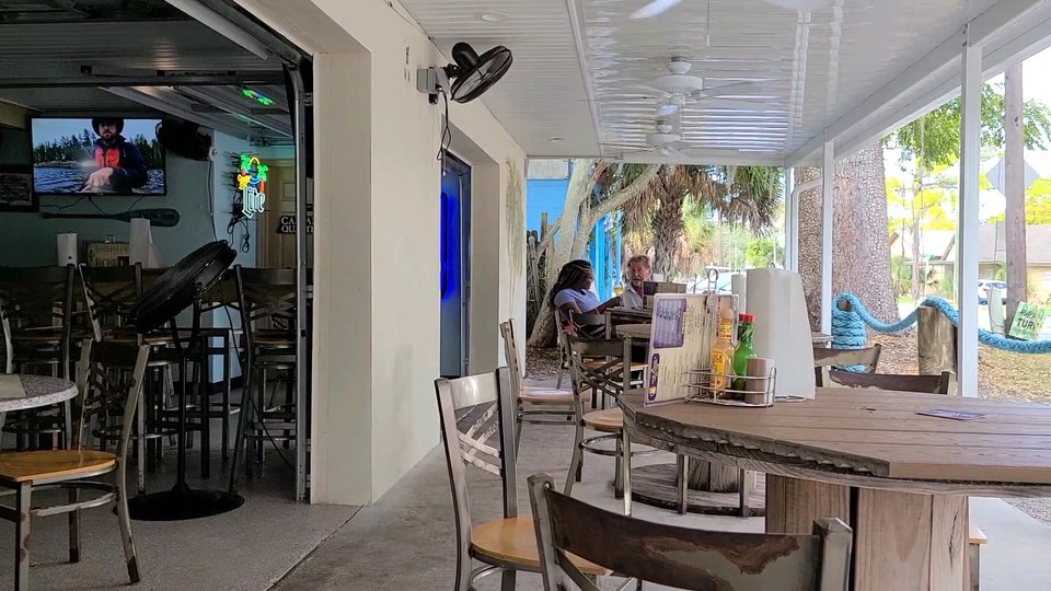 Patio seating under open-air cover.